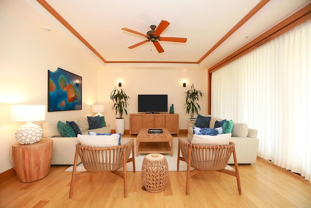 living room with ceiling fan, light hardwood / wood-style flooring, and crown molding