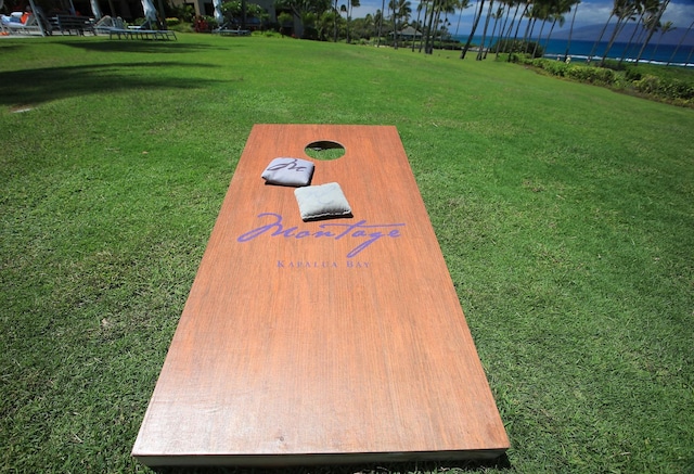 view of storm shelter featuring a lawn and a water view