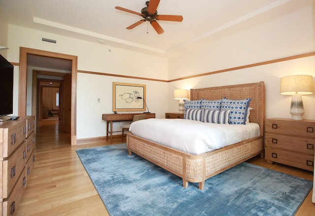 bedroom with ceiling fan and light hardwood / wood-style flooring