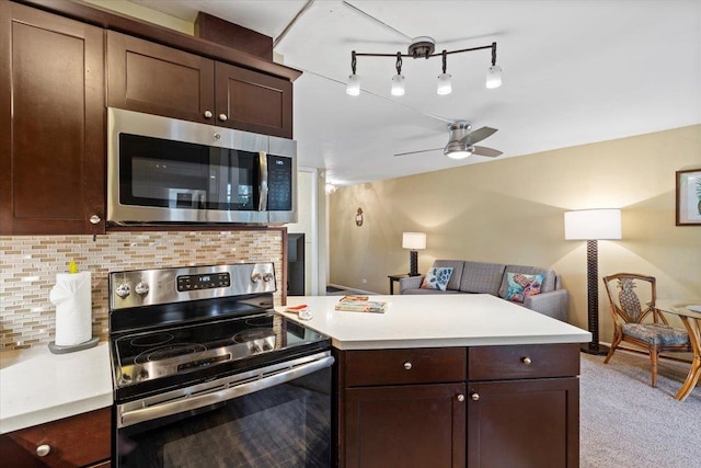 kitchen with ceiling fan, tasteful backsplash, dark brown cabinetry, stainless steel appliances, and kitchen peninsula