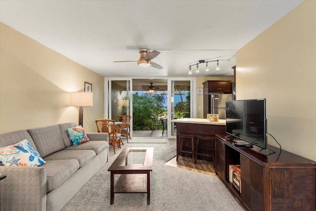 living room featuring light carpet and ceiling fan