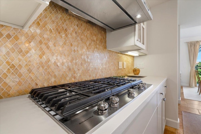 357 Umeke St Unit 144, Kihei, HI 96753 - kitchen featuring baseboards, light countertops, white cabinetry, backsplash, and stainless steel gas stovetop