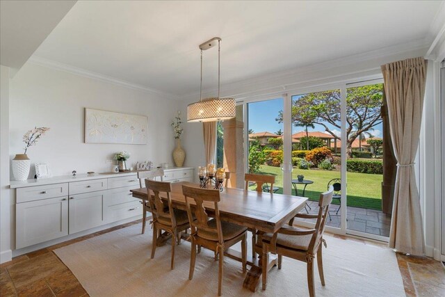 357 Umeke St Unit 144, Kihei, HI 96753 - dining area featuring crown molding and stone tile flooring