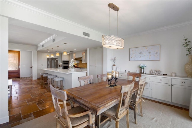 357 Umeke St Unit 144, Kihei, HI 96753 - dining space with visible vents, ornamental molding, baseboards, and stone tile floors