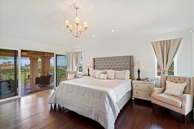 357 Umeke St Unit 144, Kihei, HI 96753 - bedroom featuring an inviting chandelier, multiple windows, dark wood finished floors, and access to exterior