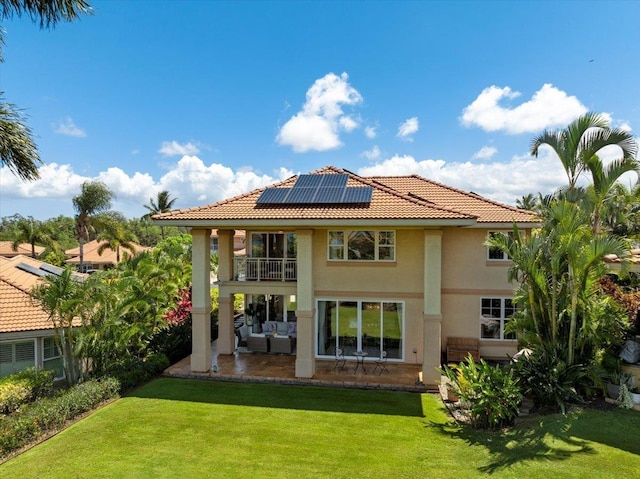 357 Umeke St Unit 144, Kihei, HI 96753 - back of house featuring a yard, roof mounted solar panels, an outdoor living space, and a balcony