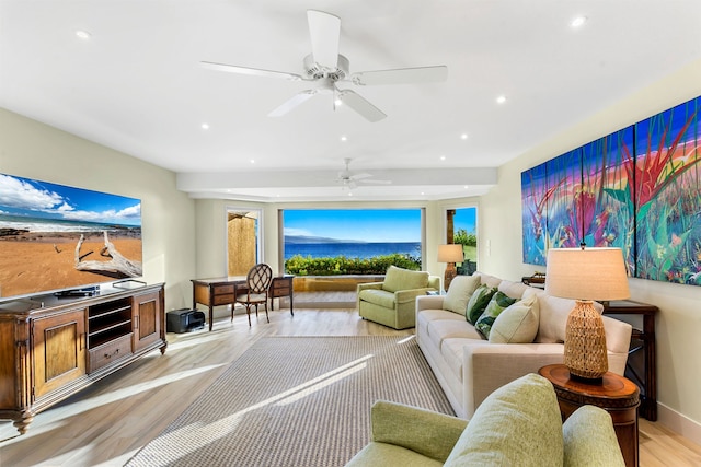 living room featuring ceiling fan and light hardwood / wood-style floors