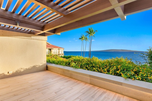 view of patio with a water view and a pergola