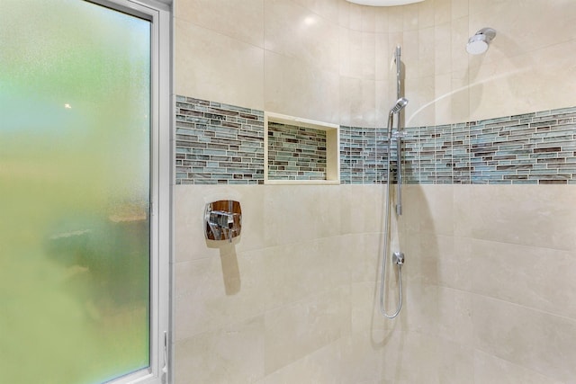 bathroom with tiled shower