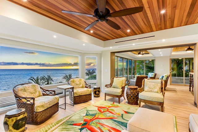 sunroom with a water view, wooden ceiling, and a tray ceiling