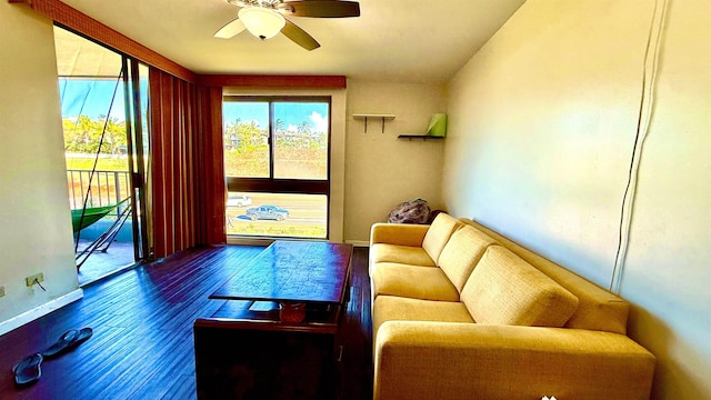 living room featuring ceiling fan and wood-type flooring