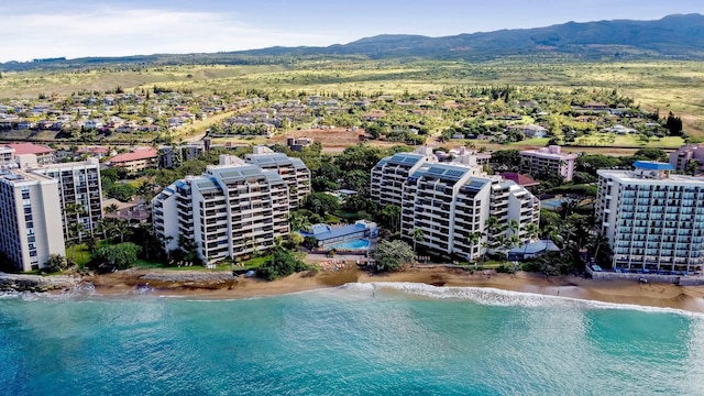 aerial view featuring a view of the beach and a water and mountain view