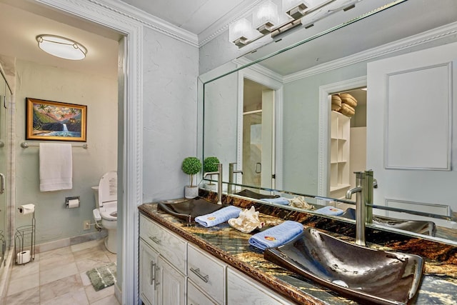 full bathroom with a stall shower, vanity, crown molding, and toilet