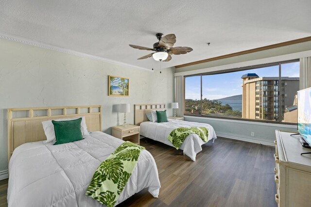 bedroom featuring a ceiling fan, dark wood finished floors, ornamental molding, and multiple windows