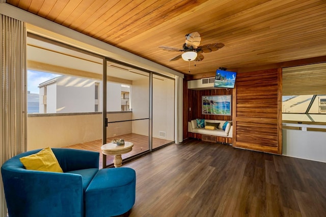 living area featuring visible vents, a ceiling fan, wood finished floors, and wooden ceiling