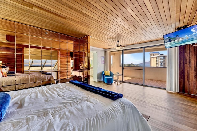 bedroom with wood ceiling, wood finished floors, and access to exterior