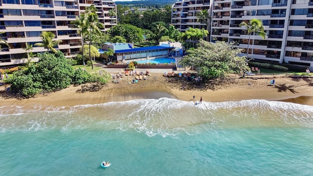 drone / aerial view with a beach view and a water view