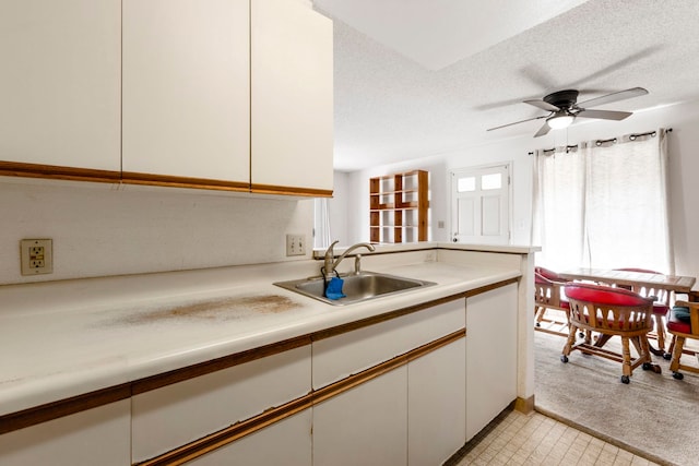 140 Uwapo Rd Unit 18-203, Kihei, HI 96753 - kitchen featuring light countertops, white cabinetry, ceiling fan, a textured ceiling, and light colored carpet
