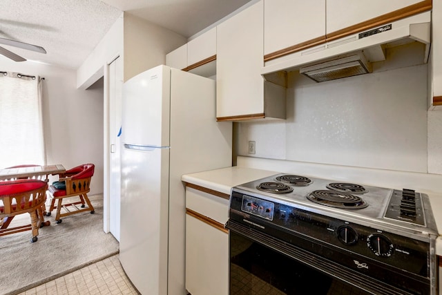 140 Uwapo Rd Unit 18-203, Kihei, HI 96753 - kitchen with electric stove, under cabinet range hood, freestanding refrigerator, light countertops, and ceiling fan