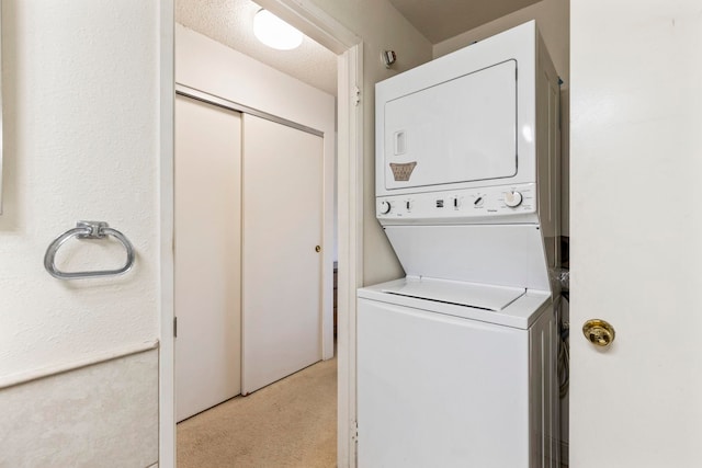 140 Uwapo Rd Unit 18-203, Kihei, HI 96753 - laundry area featuring stacked washing machine and dryer and light colored carpet