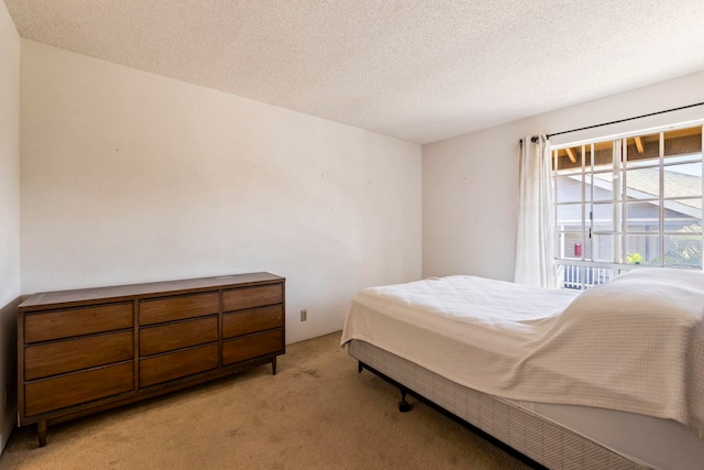 140 Uwapo Rd Unit 18-203, Kihei, HI 96753 - bedroom featuring light colored carpet and a textured ceiling