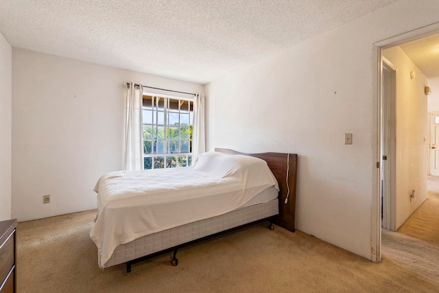 140 Uwapo Rd Unit 18-203, Kihei, HI 96753 - bedroom featuring light colored carpet and a textured ceiling