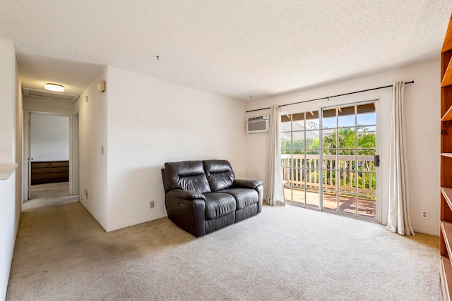 140 Uwapo Rd Unit 18-203, Kihei, HI 96753 - living area with carpet flooring, a textured ceiling, a wall unit AC, and attic access