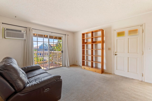 140 Uwapo Rd Unit 18-203, Kihei, HI 96753 - sitting room with carpet floors, a textured ceiling, and a wall unit AC