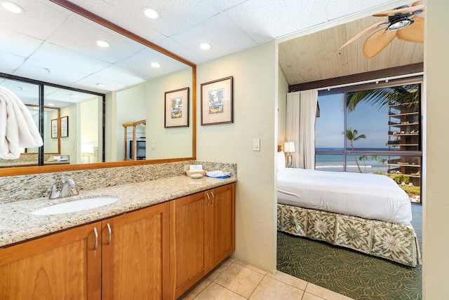 bathroom with ceiling fan, vanity, and tile patterned flooring