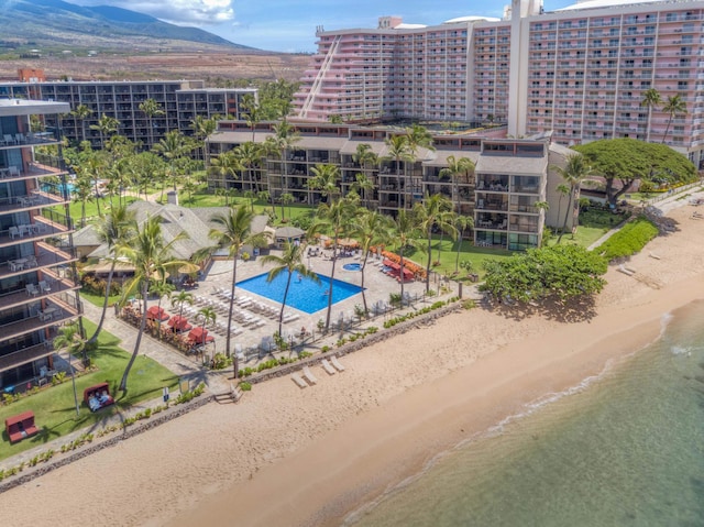 drone / aerial view featuring a beach view and a water and mountain view