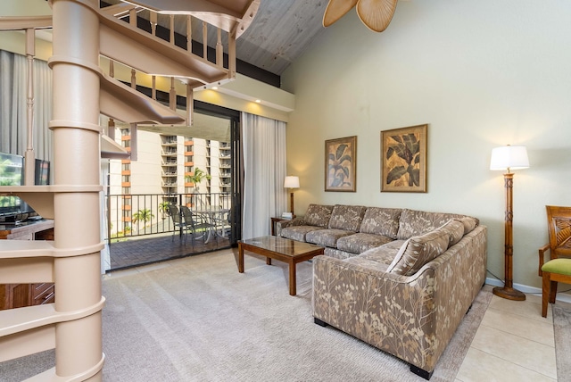 carpeted living room featuring ceiling fan and high vaulted ceiling