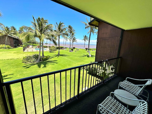 balcony with a swimming pool and a water view