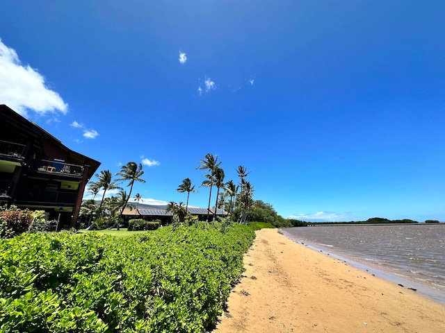 view of road featuring a view of the beach and a water view