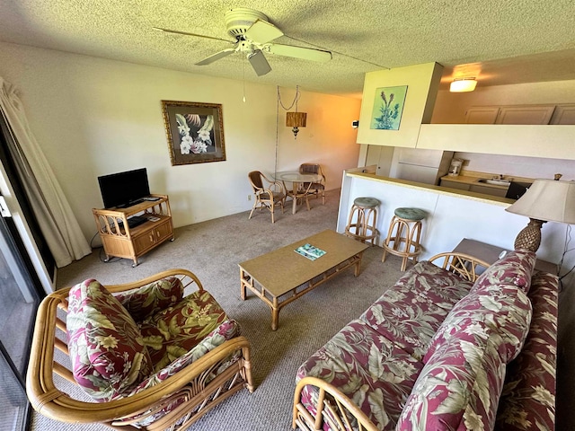 carpeted living room with ceiling fan and a textured ceiling