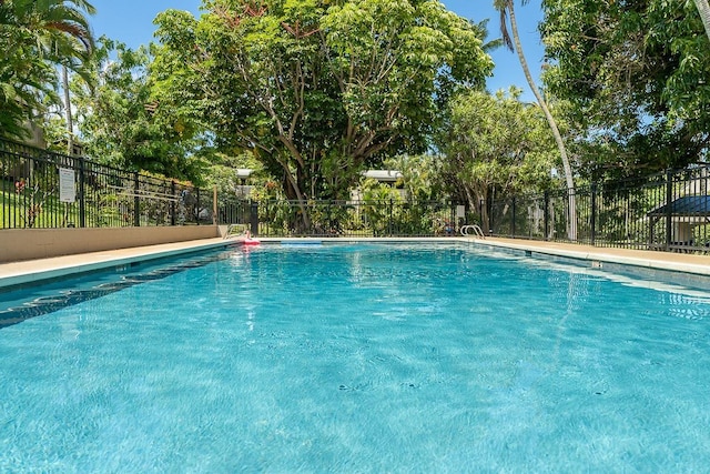 community pool featuring fence