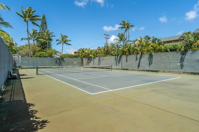 view of tennis court featuring fence