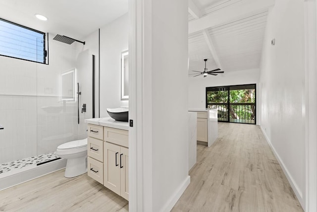 bathroom featuring toilet, wood finished floors, and a stall shower