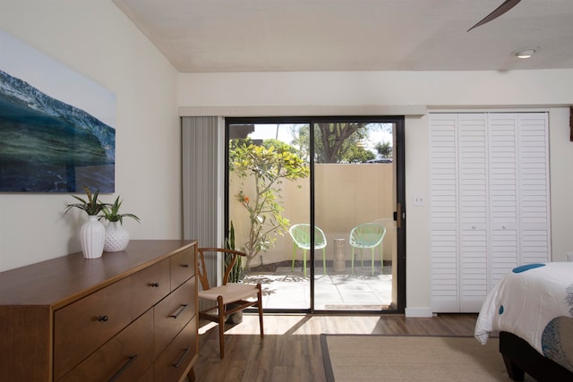 bedroom with a closet, ceiling fan, access to outside, and dark wood-type flooring