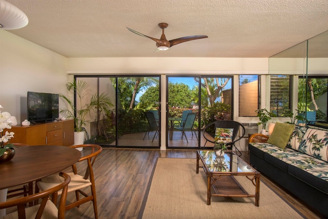 living room featuring plenty of natural light, ceiling fan, hardwood / wood-style flooring, and a textured ceiling