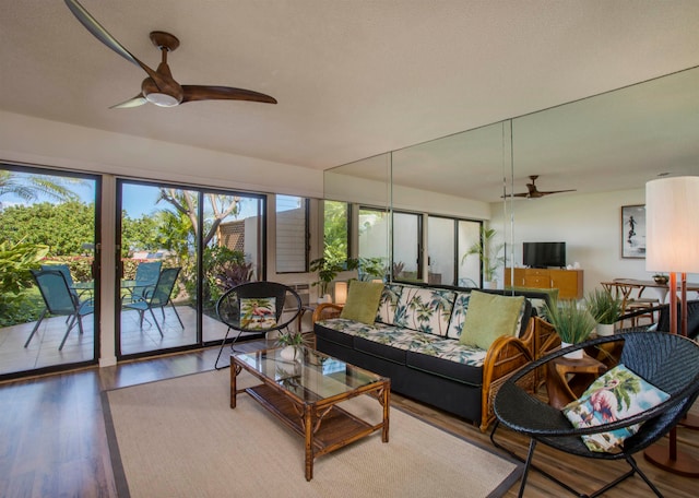 living room with hardwood / wood-style floors and ceiling fan