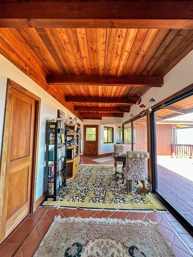 unfurnished living room featuring wooden ceiling, tile patterned floors, and beamed ceiling