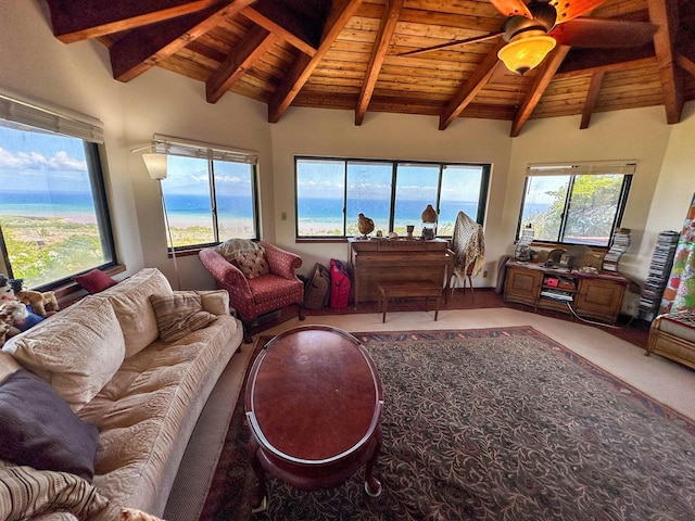 living room featuring lofted ceiling with beams, carpet floors, ceiling fan, a water view, and wooden ceiling