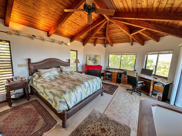 carpeted bedroom featuring ceiling fan, multiple windows, and lofted ceiling with beams