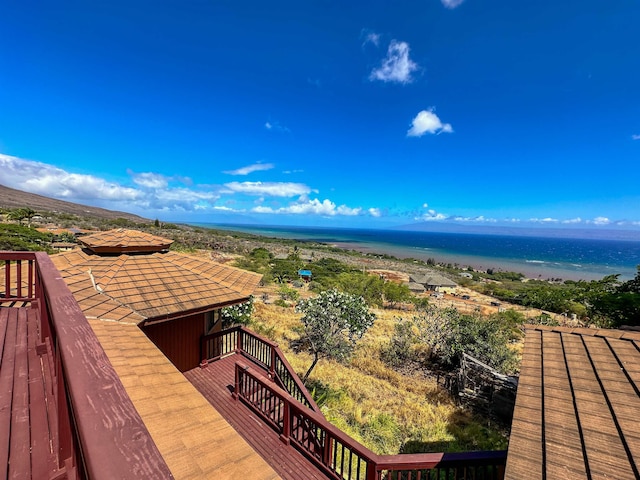 wooden deck featuring a view of the beach and a water view