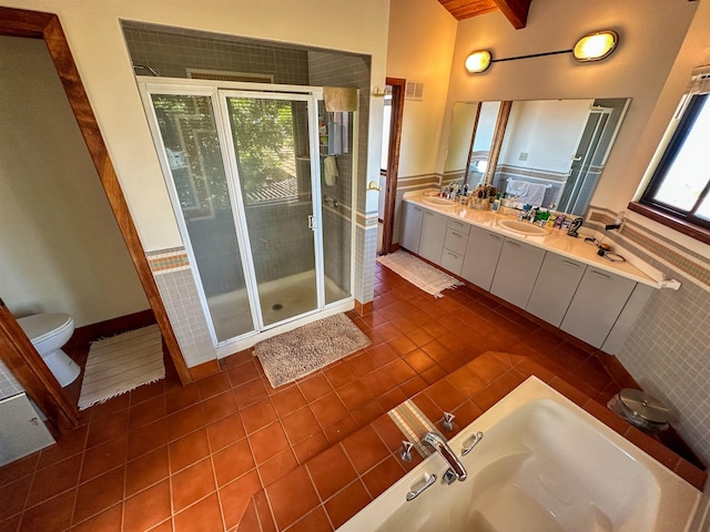 full bathroom featuring shower with separate bathtub, beamed ceiling, vanity, toilet, and tile patterned floors