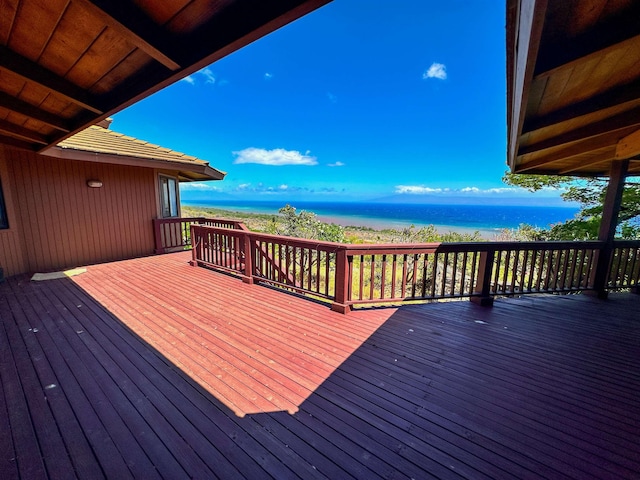 wooden terrace featuring a water view