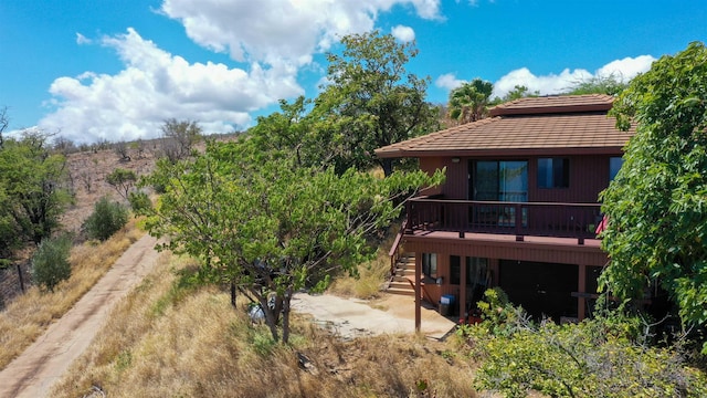 rear view of house featuring a wooden deck