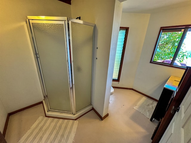 bathroom featuring vanity, toilet, concrete floors, and walk in shower