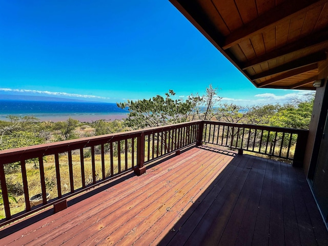 wooden deck featuring a water view and a beach view