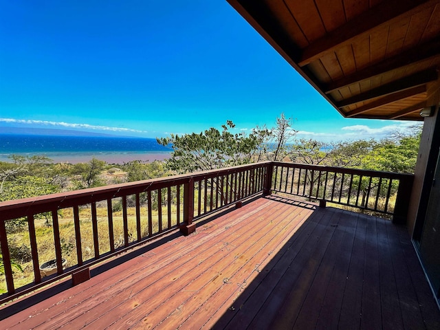 wooden deck featuring a water view and a view of the beach